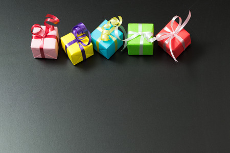 Multicolor gift boxes on black background, with copy space