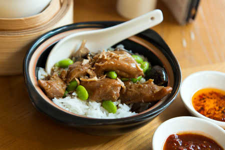 Close up of claypot chicken rice served with mushroom and green peasの写真素材