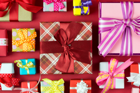 Close up of multicolor gift boxes on red backgroundの写真素材