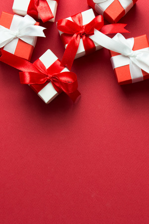 Red and white gift boxes on red background with copy spaceの写真素材