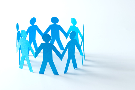 Cut out of blue paper people form in a circleの写真素材