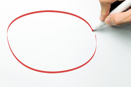 Hand draw big empty circle with red maker pen on white backgroundの写真素材