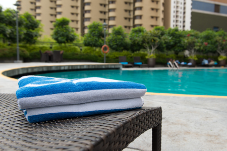 Close up of towels on deck chair at resort poolの写真素材