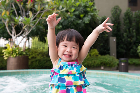 Portrait of little Asian kid at the swimming poolの写真素材