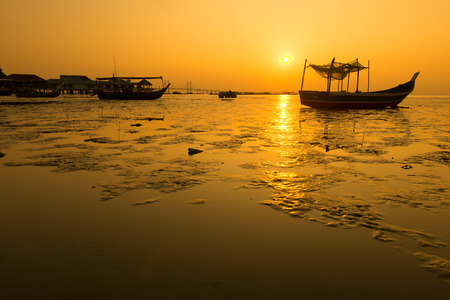 Fishing boats on dock and sunset in Penang, Malaysiaの写真素材