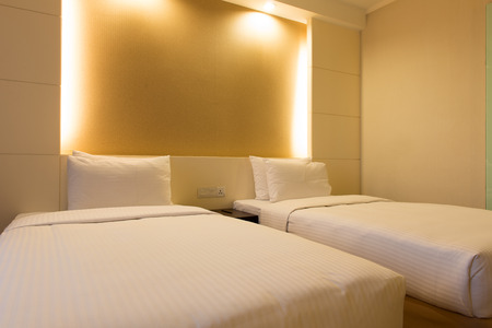 Interior of twin bed in hotel bedroomの写真素材