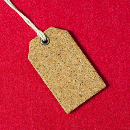Blank price tag or gift tag on red backgroundの写真素材