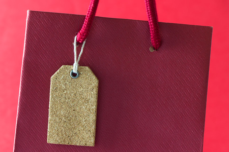 Close up of blank tag on red paper tagの写真素材