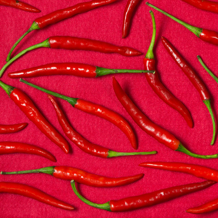 Close up of red chili peppers forming backgroundの写真素材