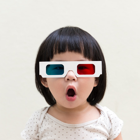 Asian little child wearing 3d glasses over white background
