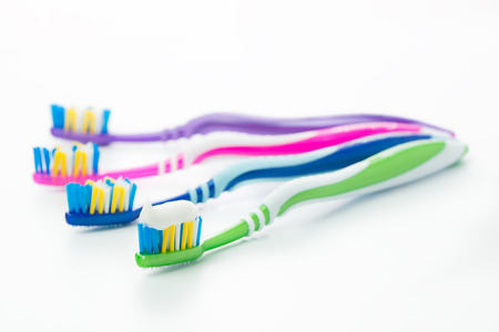 Close up of multicolor toothbrushes isolated on white backgroundの写真素材