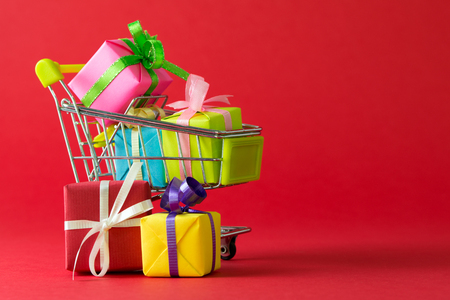 Shopping cart filled with variety color of gift boxesの写真素材
