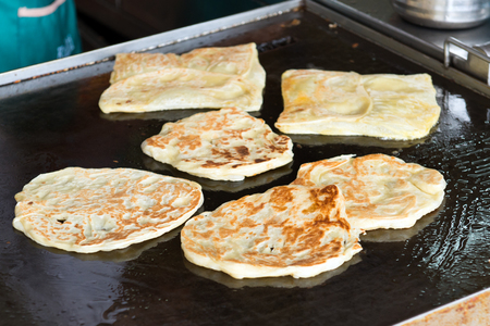 Close up of pan fry Indian flat bread, roti canai in the hawker stallの写真素材