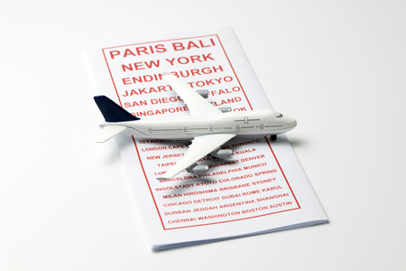 Travel leaflet with a model airplane on top
