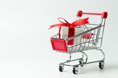 Red gift or presents box in a shopping cart, for sales promotion and rewards conceptの写真素材