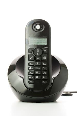 Black cordless phone with charging station isolated on white backgroundの写真素材