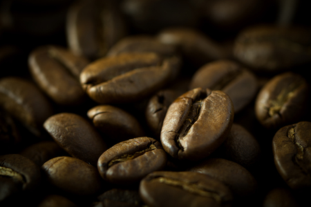 Closeup of coffee roasted beans, macro and low key photo