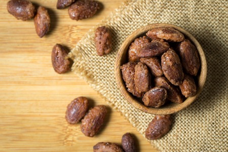 Sugar, honey or caramel coated roast almond in bowlの写真素材