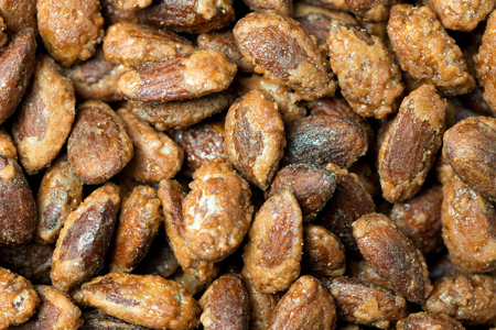 Sugar, honey or caramel coated roast almond in bowlの写真素材