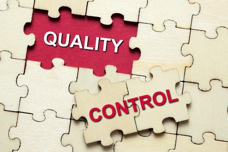 Jigsaw puzzle pieces with word quality controlの写真素材