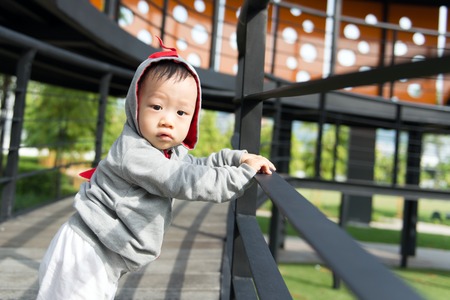 Portrait of little Asian baby boy at outdoor parkの写真素材