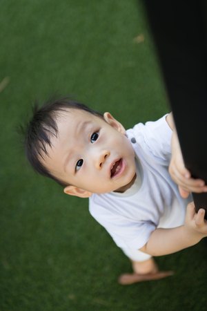 Portrait of little Asian baby boy at outdoor parkの写真素材