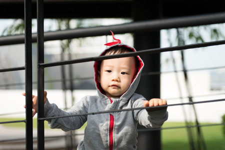 Portrait of little Asian baby boy at outdoor parkの写真素材