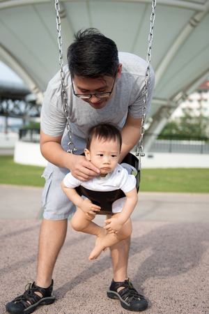Asian father and son are enjoying beautiful summer outdoor