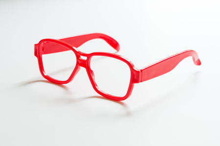 Red color spectacles frame isolated on white backgroundの写真素材
