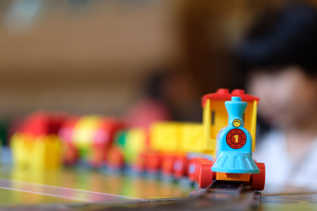 Little girl kid playing with plastic train toyの写真素材