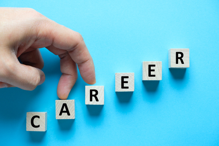 Wooden blocks arranged in stair shape with word career for career growth conceptualの写真素材