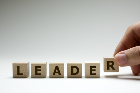Leader word made from wood cubes or blocks with letters alphabetの写真素材