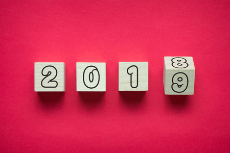 Wooden cubes in red color symbolically changes from 2018 to 2019の写真素材