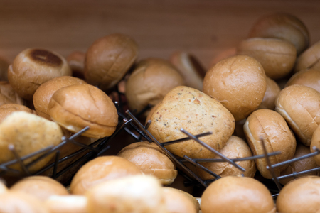 Pile of hot fresh bread bun comparing of whole wheat bun to plain bun for breakfast in the morning.の写真素材
