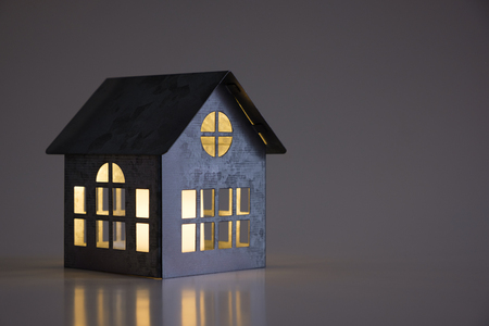 Miniature model metal house on a dark backgroundの写真素材