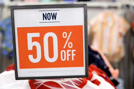 Red sale sign with 50 percent discount off in store
