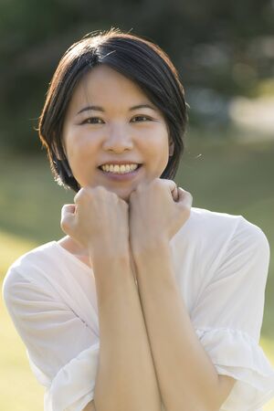 Portrait young Asian woman outdoor back light in spring or summerの写真素材