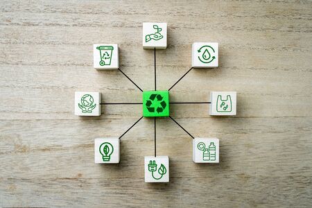 Recyling icons and symbols on wooden square bricks in circle