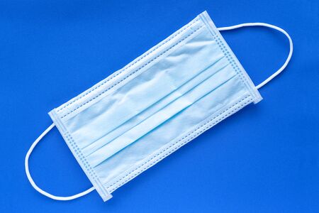 Typical 3 ply surgical face mask with rubber ear straps to cover the mouth and nose