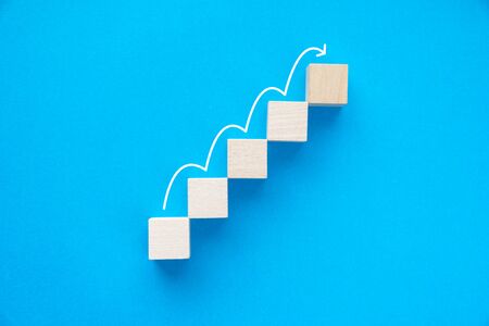 Wood block stacking as step stair up, ladder career path concept for business growth success process