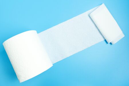 One toilet paper roll open isolated on blueの写真素材