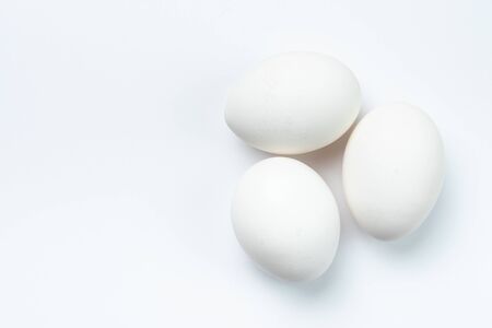 Three white chicken eggs isolated on white backgroundの写真素材
