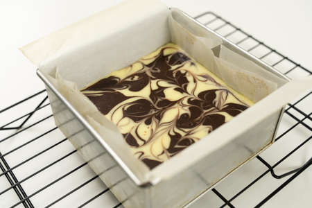 Homemade cheesecake swirl brownie on cooling rack