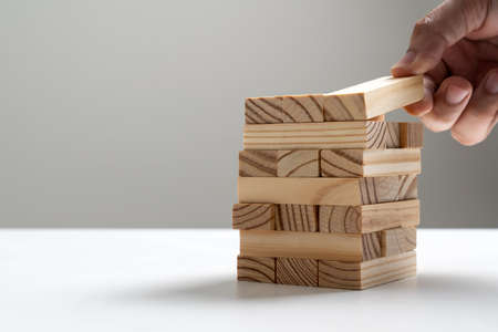 Hand of engineer stack a block wood for architectural projectの写真素材