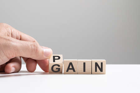 No pain no gain concept, hand flip wood cube change the word from pain to gainの写真素材