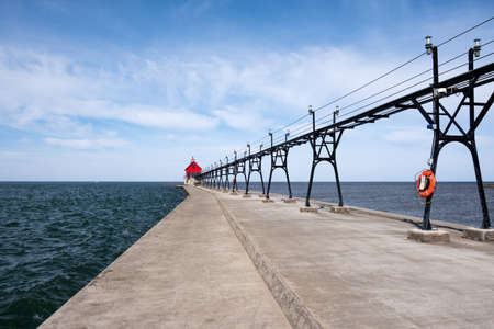 Landscape of the Grand Haven Lighthouse, pier, and catwalk at morning, Lake Michigan, Michigan, USAの写真素材