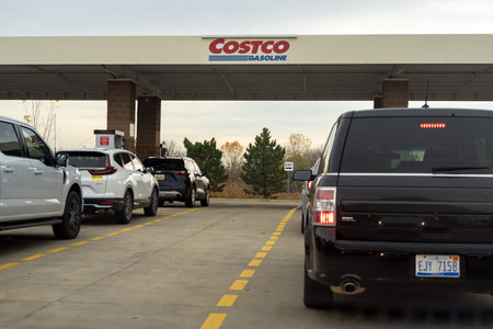 Novi, Michigan, USA - Oct 30, 2022: People in cars waiting in long lines to fill up vehicles with...