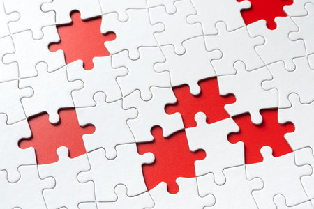 Puzzle on red background with missing piecesの写真素材