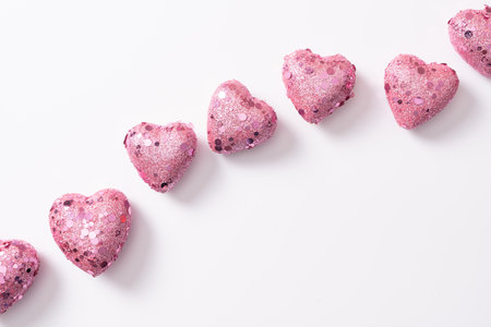Glittery pink hearts lined up for valentines day background