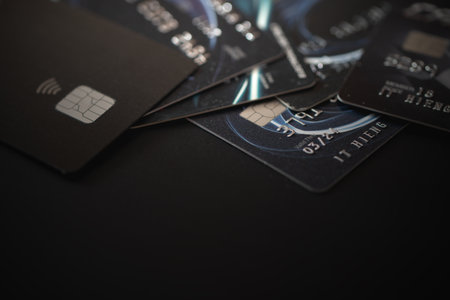 Numerous credit cards scattered on black backgroundの写真素材